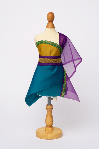 Mashquin styled with a purple wrap top and yellow skirt using the Tropical Twilight fabrics — a creative slow-fashion accessory for kids’ design play.