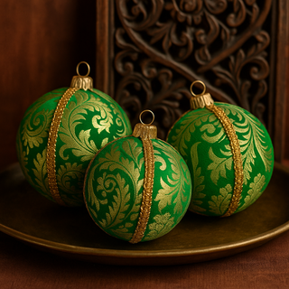 Three Nalin Baubles placed on a traditional brass tray next to a diya and intricate carved decor, styled with mustard and green tones for a subtle Indian touch.