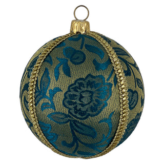 A close-up image of the Ranbir Bauble featuring teal floral brocade fabric with gold braid trim, highlighting its detailed pattern and craftsmanship.