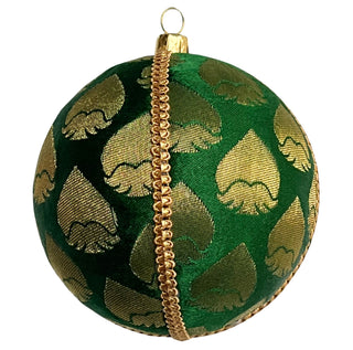 single rayansh bauble one a black background to show beauty. Rayansh Bauble – 10cm handmade fabric ornament in emerald green brocade with gold leaf motifs, luxury sustainable décor