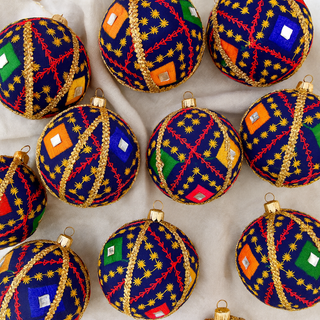 Taarush Bauble – 10cm navy fabric ornament with multicoloured embroidery, mirror accents, and gold trim, handmade in the UK.