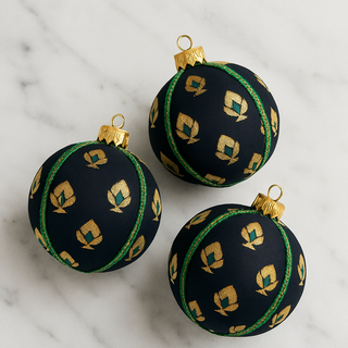Tamasvi Bauble – 8cm black brocade ornament with gold motifs and emerald trim, handmade in the UK.
